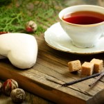 Spiced tea and ginger biscuits on a wooden table.